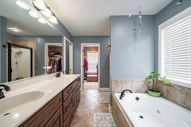9597 Yarbrough Rd, Midland, GA 31820 - bathroom with a shower stall, a tub with jets, double vanity, tile patterned floors, and a spacious closet