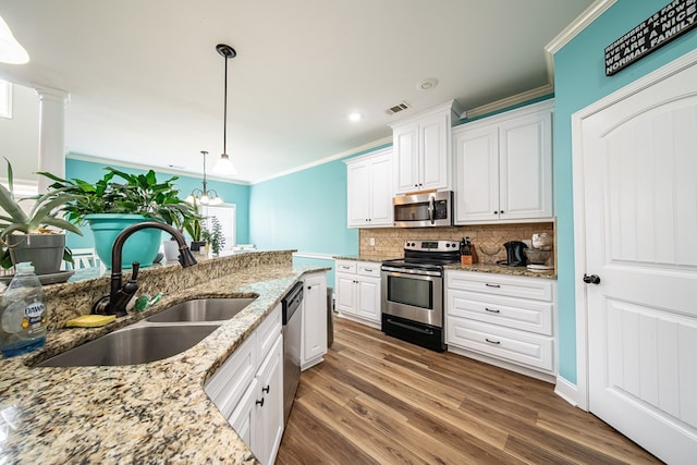 9597 Yarbrough Rd, Midland, GA 31820 - kitchen featuring appliances with stainless steel finishes, crown molding, a sink, white cabinets, and backsplash