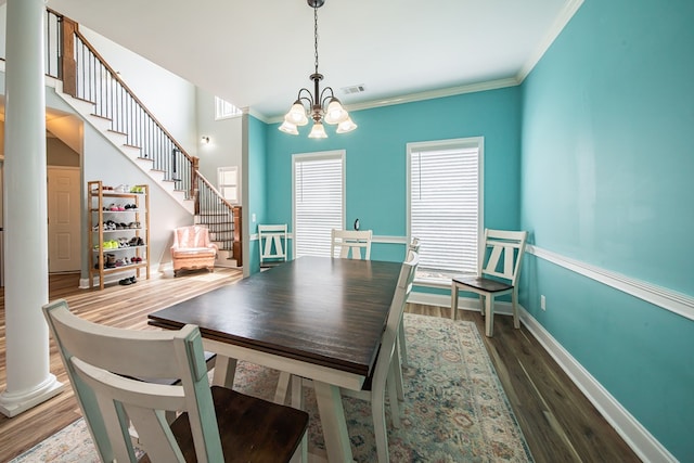 9597 Yarbrough Rd, Midland, GA 31820 - dining area with a chandelier, stairs, wood finished floors, baseboards, and ornamental molding