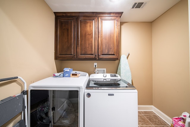 9597 Yarbrough Rd, Midland, GA 31820 - laundry area with washing machine and dryer, cabinet space, baseboards, and tile patterned floors