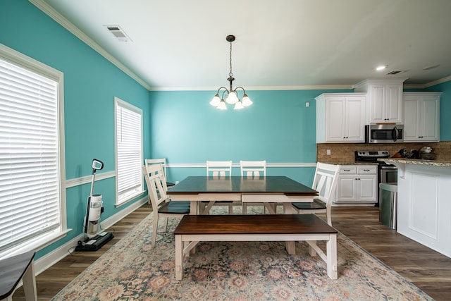 9597 Yarbrough Rd, Midland, GA 31820 - dining area featuring a chandelier, dark wood-type flooring, ornamental molding, and baseboards