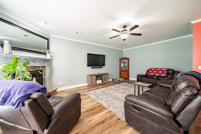 9597 Yarbrough Rd, Midland, GA 31820 - living area featuring a stone fireplace, baseboards, ceiling fan, crown molding, and wood finished floors