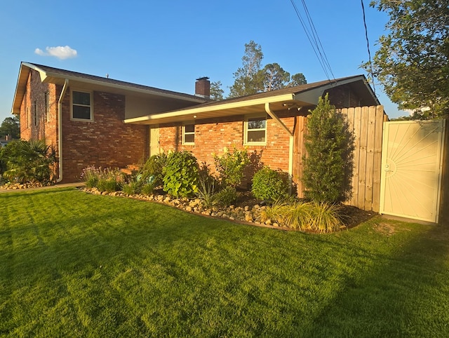 2914 Sue Mack Dr, Columbus, GA 31906 - view of side of property with a chimney, a lawn, and brick siding