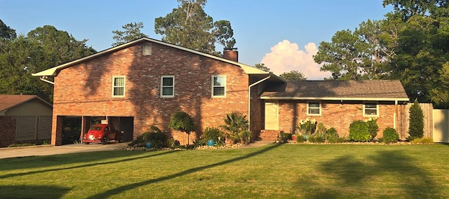 2914 Sue Mack Dr, Columbus, GA 31906 - split level home featuring a chimney, a front lawn, and brick siding