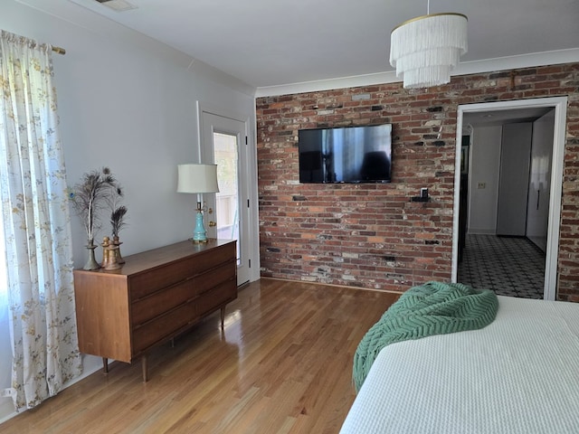 2914 Sue Mack Dr, Columbus, GA 31906 - bedroom featuring wood finished floors and brick wall