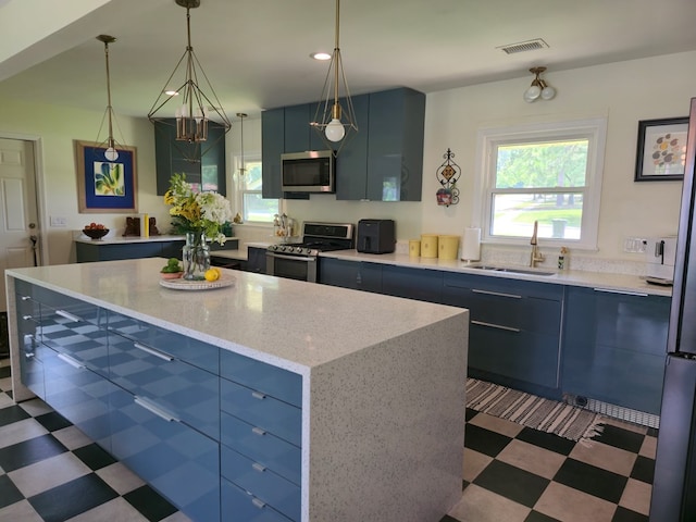 2914 Sue Mack Dr, Columbus, GA 31906 - kitchen featuring stainless steel appliances, dark floors, healthy amount of natural light, blue cabinetry, and recessed lighting