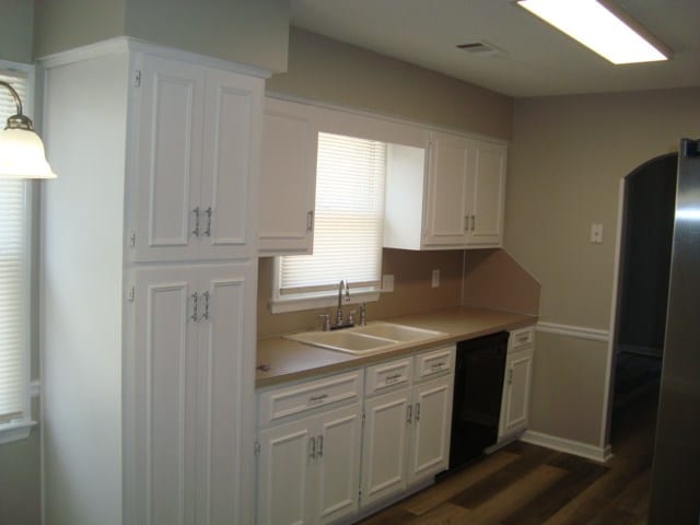 4118 Terrace Pointe Dr, Columbus, GA 31909 - kitchen featuring dark wood-style flooring, white cabinetry, light countertops, and dishwasher