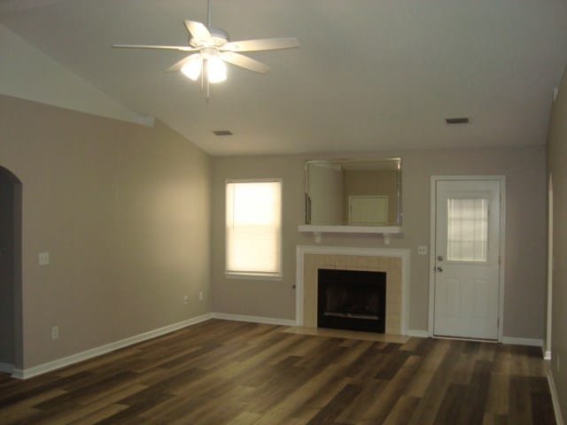 4118 Terrace Pointe Dr, Columbus, GA 31909 - unfurnished living room featuring a ceiling fan, vaulted ceiling, wood finished floors, a fireplace, and arched walkways