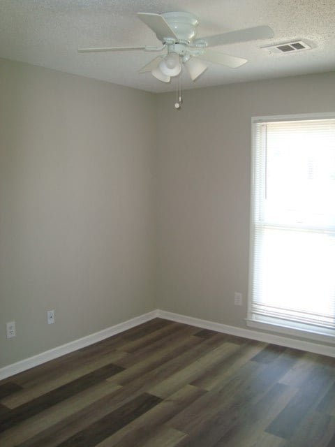 4118 Terrace Pointe Dr, Columbus, GA 31909 - empty room featuring dark wood-style floors, a ceiling fan, and a textured ceiling