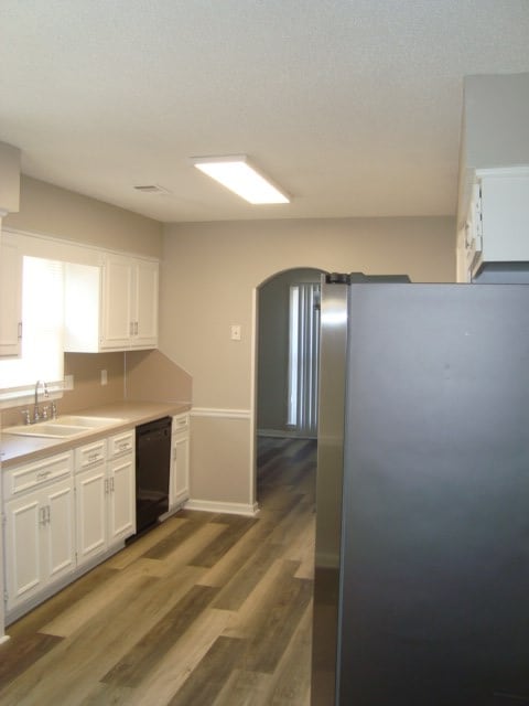 4118 Terrace Pointe Dr, Columbus, GA 31909 - kitchen featuring dishwasher, freestanding refrigerator, white cabinets, and wood finished floors