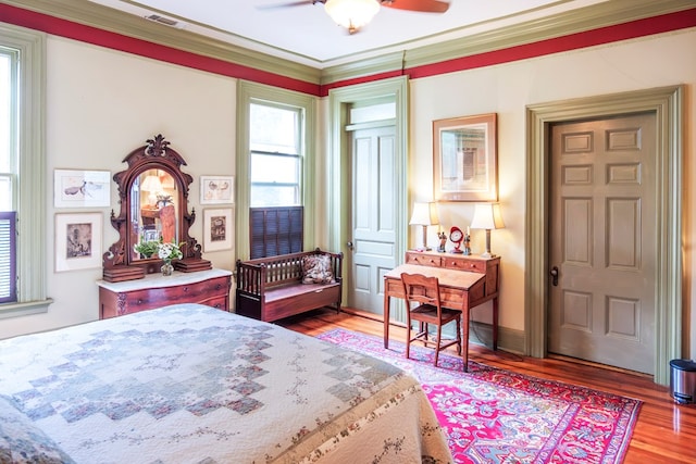 bedroom with ceiling fan, light hardwood / wood-style flooring, and ornamental molding