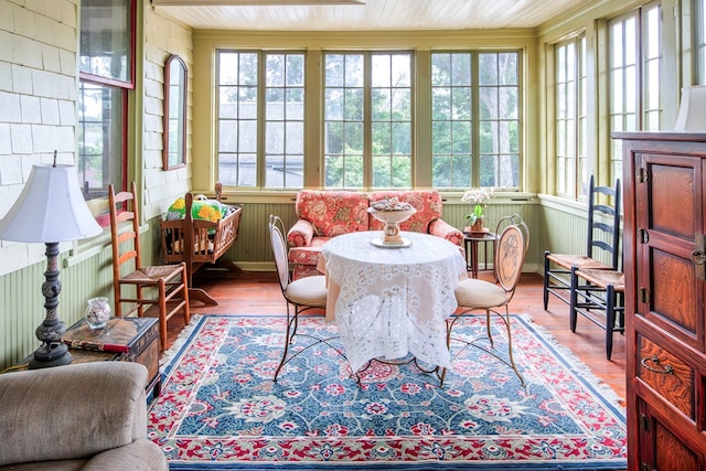 sunroom featuring plenty of natural light and wood ceiling