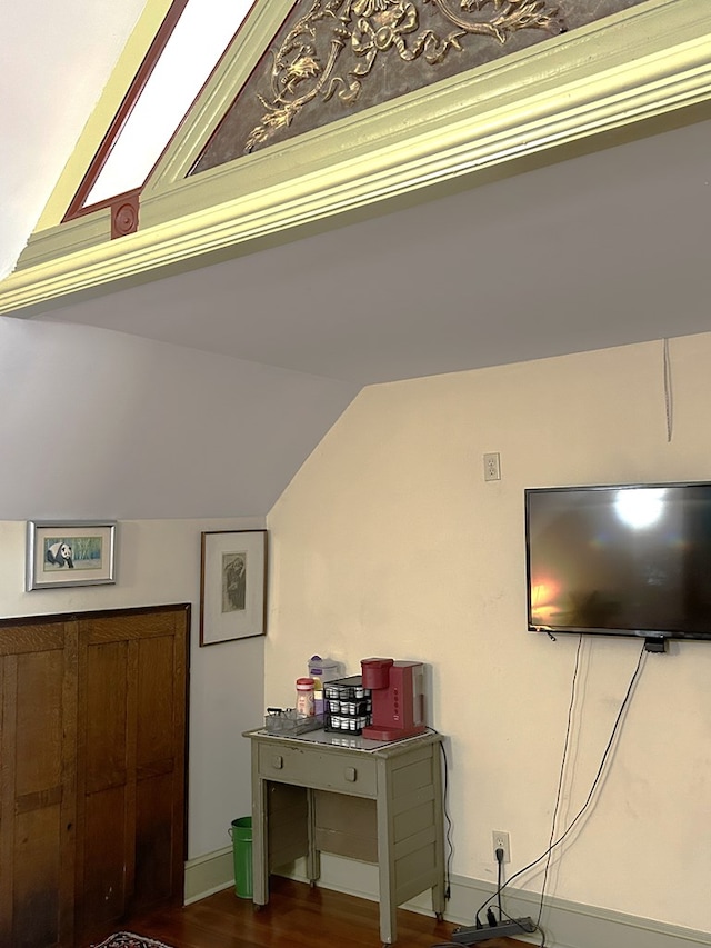 interior space with dark hardwood / wood-style flooring and lofted ceiling