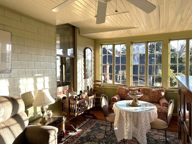 sunroom featuring ceiling fan and wooden ceiling