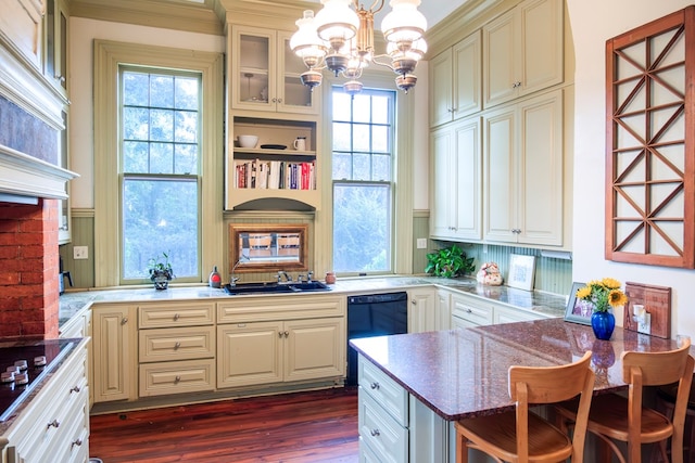 kitchen featuring kitchen peninsula, pendant lighting, dark hardwood / wood-style floors, and a notable chandelier