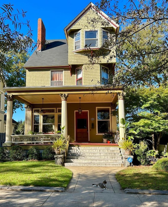 view of front of property with a porch and a front yard