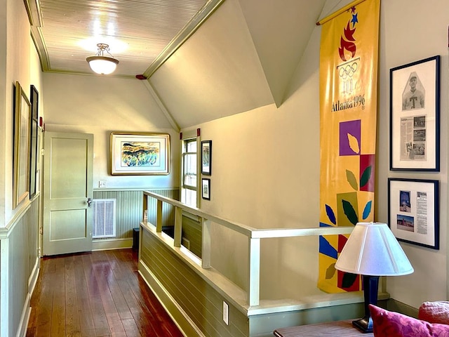 hallway featuring vaulted ceiling and dark wood-type flooring