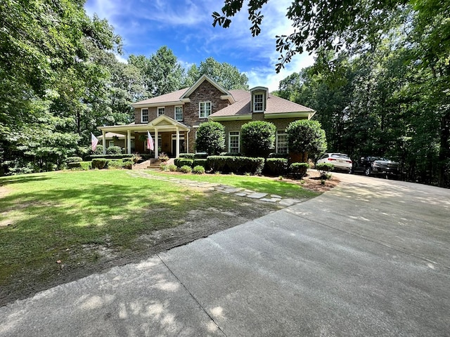 105 Lake View Dr, Hamilton, GA 31811 - view of front of house with a porch, a front lawn, concrete driveway, and brick siding
