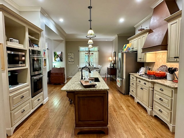 105 Lake View Dr, Hamilton, GA 31811 - kitchen featuring cream cabinetry, appliances with stainless steel finishes, crown molding, a center island with sink, and light stone countertops