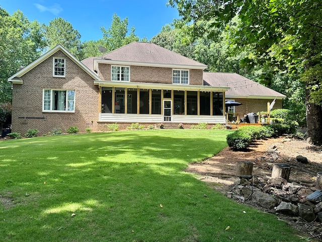 105 Lake View Dr, Hamilton, GA 31811 - back of house with a sunroom, a yard, and brick siding
