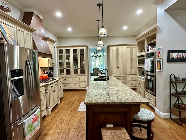 105 Lake View Dr, Hamilton, GA 31811 - kitchen featuring appliances with stainless steel finishes, cream cabinets, light wood finished floors, light stone counters, and crown molding