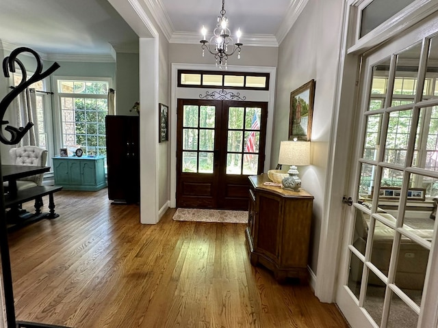 105 Lake View Dr, Hamilton, GA 31811 - foyer entrance with french doors, wood finished floors, a chandelier, and crown molding