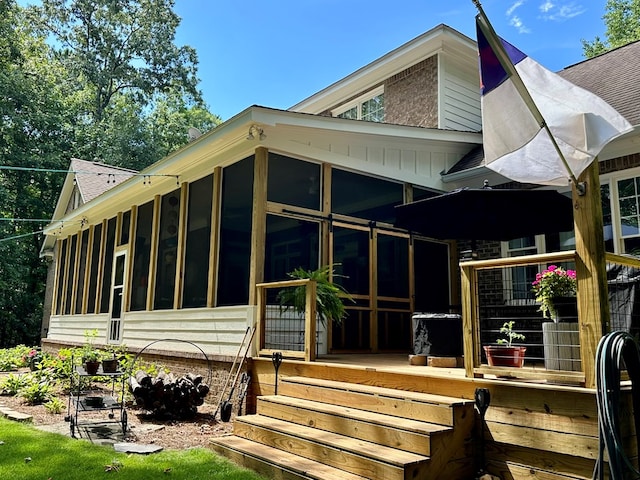 105 Lake View Dr, Hamilton, GA 31811 - rear view of house with a sunroom and roof with shingles