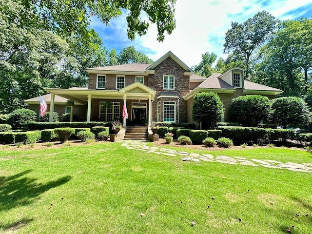 105 Lake View Dr, Hamilton, GA 31811 - view of front of house featuring a front yard, a porch, brick siding, and stone siding