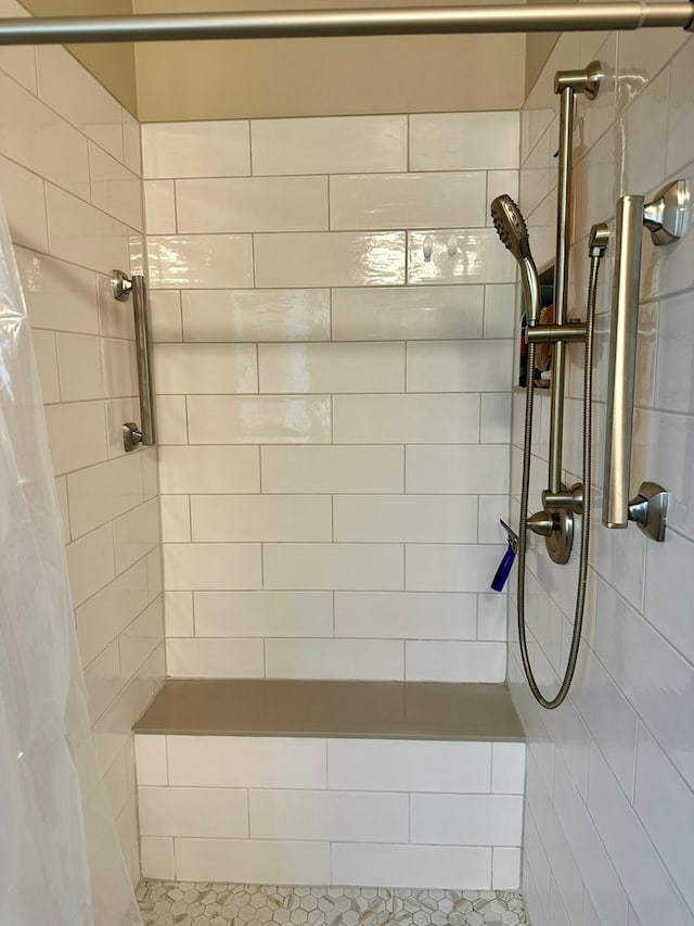 bathroom with tiled shower