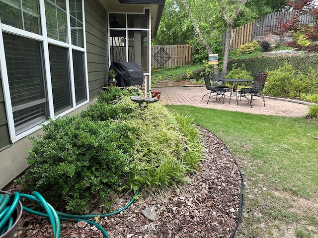 view of yard with fence and a patio