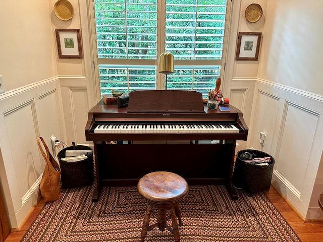 room details featuring wainscoting and a decorative wall