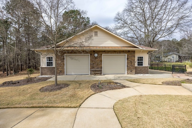 view of front facade with a front lawn, fence, and brick siding