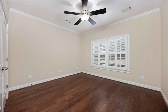 spare room featuring baseboards, crown molding, visible vents, and dark wood-type flooring