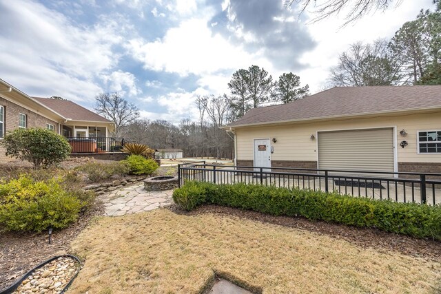 view of yard featuring a patio and an outdoor fire pit