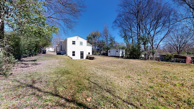 view of yard with an outbuilding and a storage unit