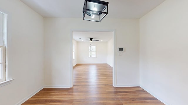 interior space featuring baseboards and wood finished floors