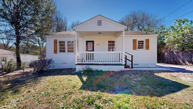 bungalow-style home featuring a porch, fence, a front lawn, and crawl space