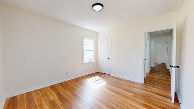 unfurnished bedroom featuring baseboards and light wood-style floors