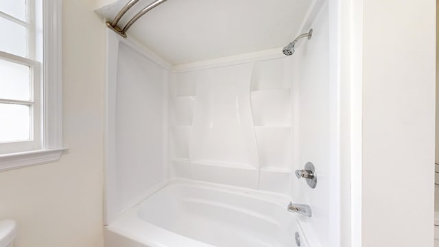 bathroom featuring toilet and shower / washtub combination