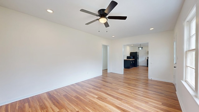 interior space with recessed lighting, baseboards, light wood-style flooring, and ceiling fan