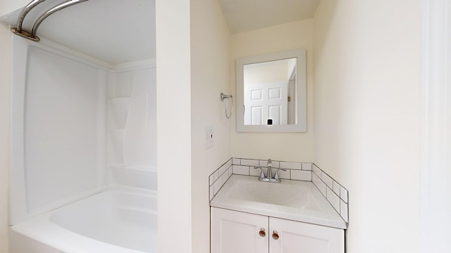 bathroom featuring vanity, a shower, and backsplash