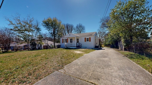 bungalow-style home featuring concrete driveway and a front lawn