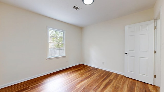 unfurnished room featuring visible vents, baseboards, and light wood-style flooring