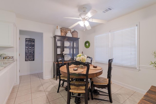 dining area featuring light tile patterned flooring, visible vents, baseboards, and ceiling fan