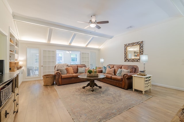 living room featuring light wood finished floors, visible vents, a ceiling fan, baseboards, and lofted ceiling with beams