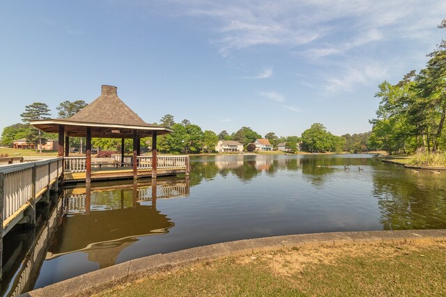 dock area with a gazebo and a water view