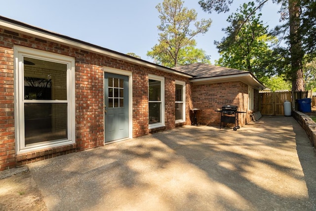 view of patio featuring a gate, area for grilling, and fence