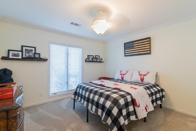 bedroom with carpet floors and crown molding