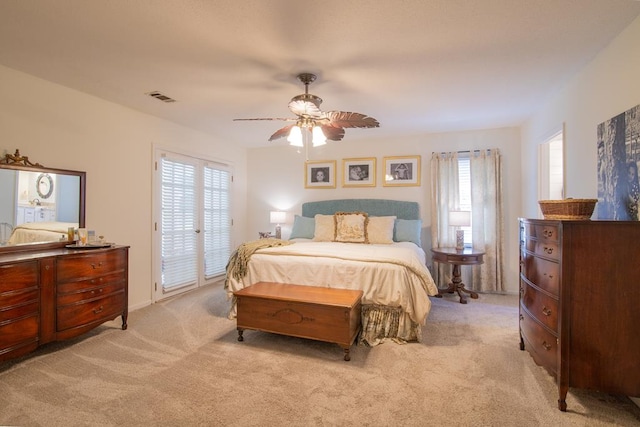 bedroom with light colored carpet, a ceiling fan, access to outside, and visible vents