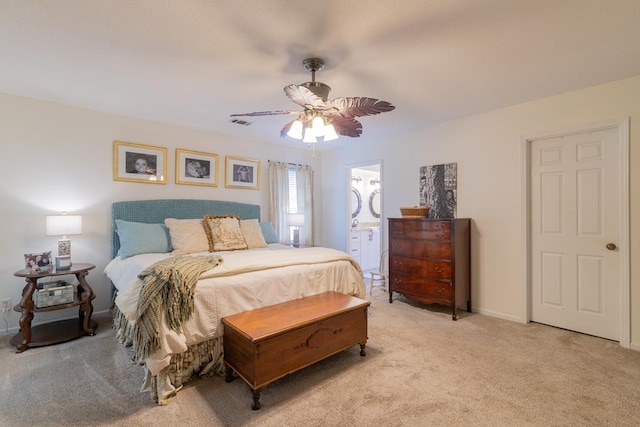bedroom featuring light carpet, a ceiling fan, visible vents, and connected bathroom
